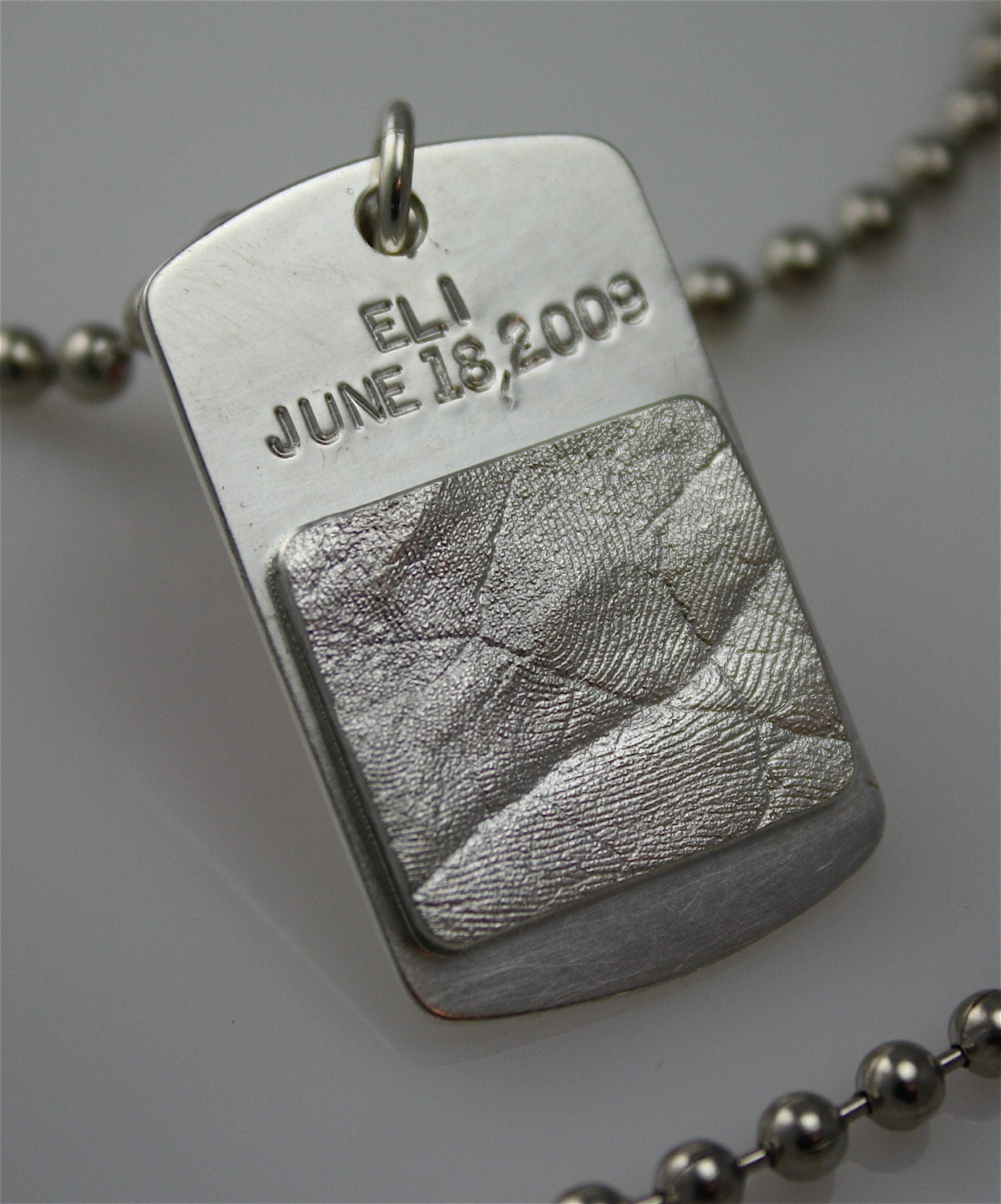 Soldiers' dog tag with son/daughters hand/foot impression in sterling