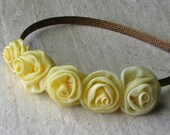 Floral headband with small roses in shades of creamy yellow, child size