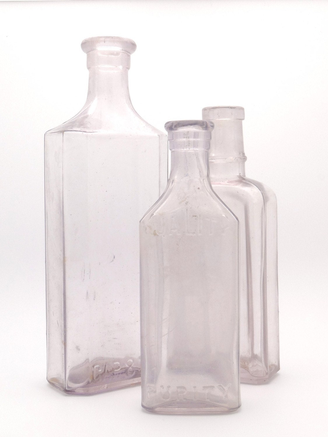 Three
 Light Purple Vintage Glass Bottles