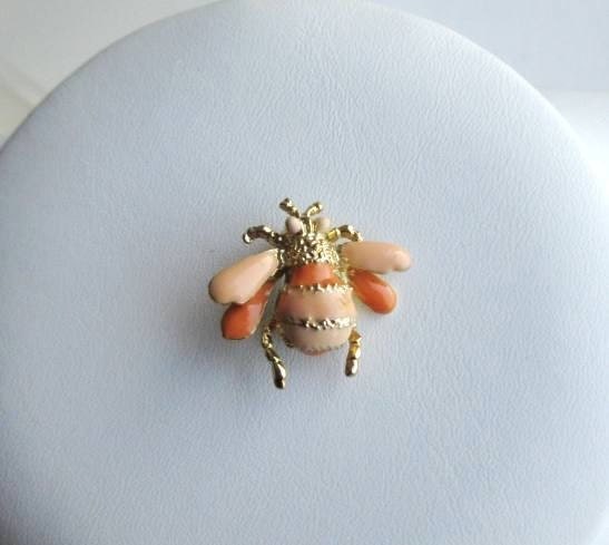 Adorable tiny bumble bee pin with coral and peach enamel body