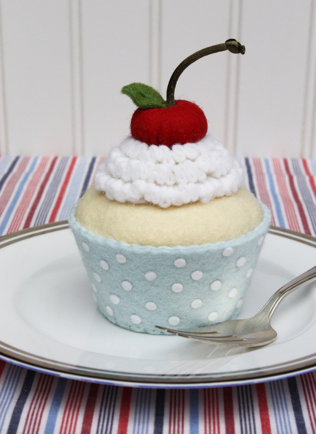 Patriotic Felt Cupcake With White Whipped Cream, Cherry And Blue Liner