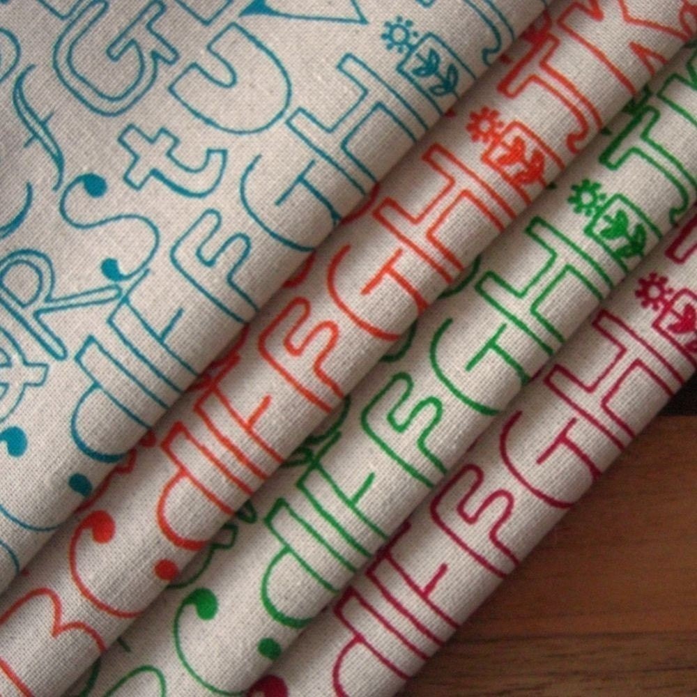 alphabetty - set of four fabrics in red, turquoise, orange and green on oatmeal