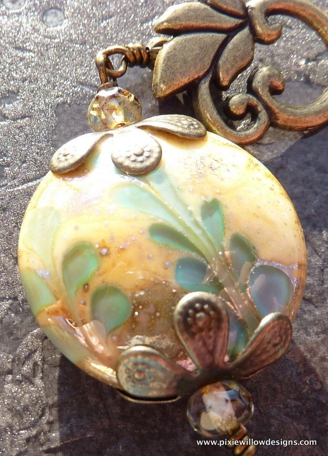 A fabulous detailed lampwork bead in tones of gold.