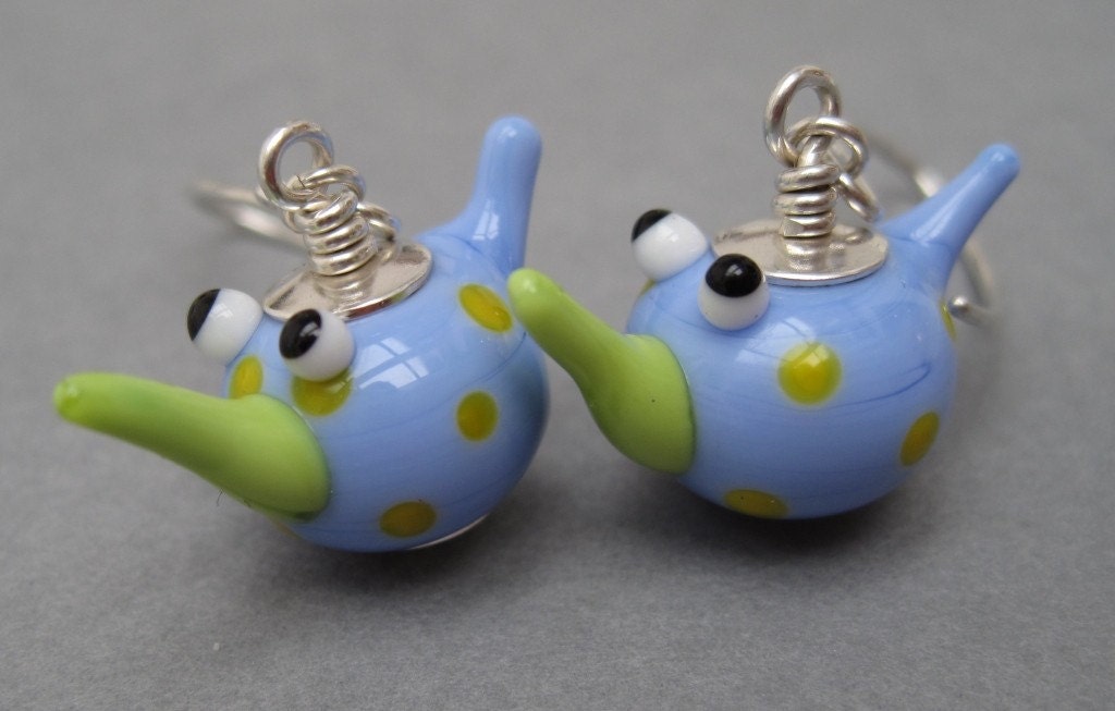 These cutesy earrings were handmade by me using lampwork bird beads by fellow etsian mad cat glass and sterling silver findings.
