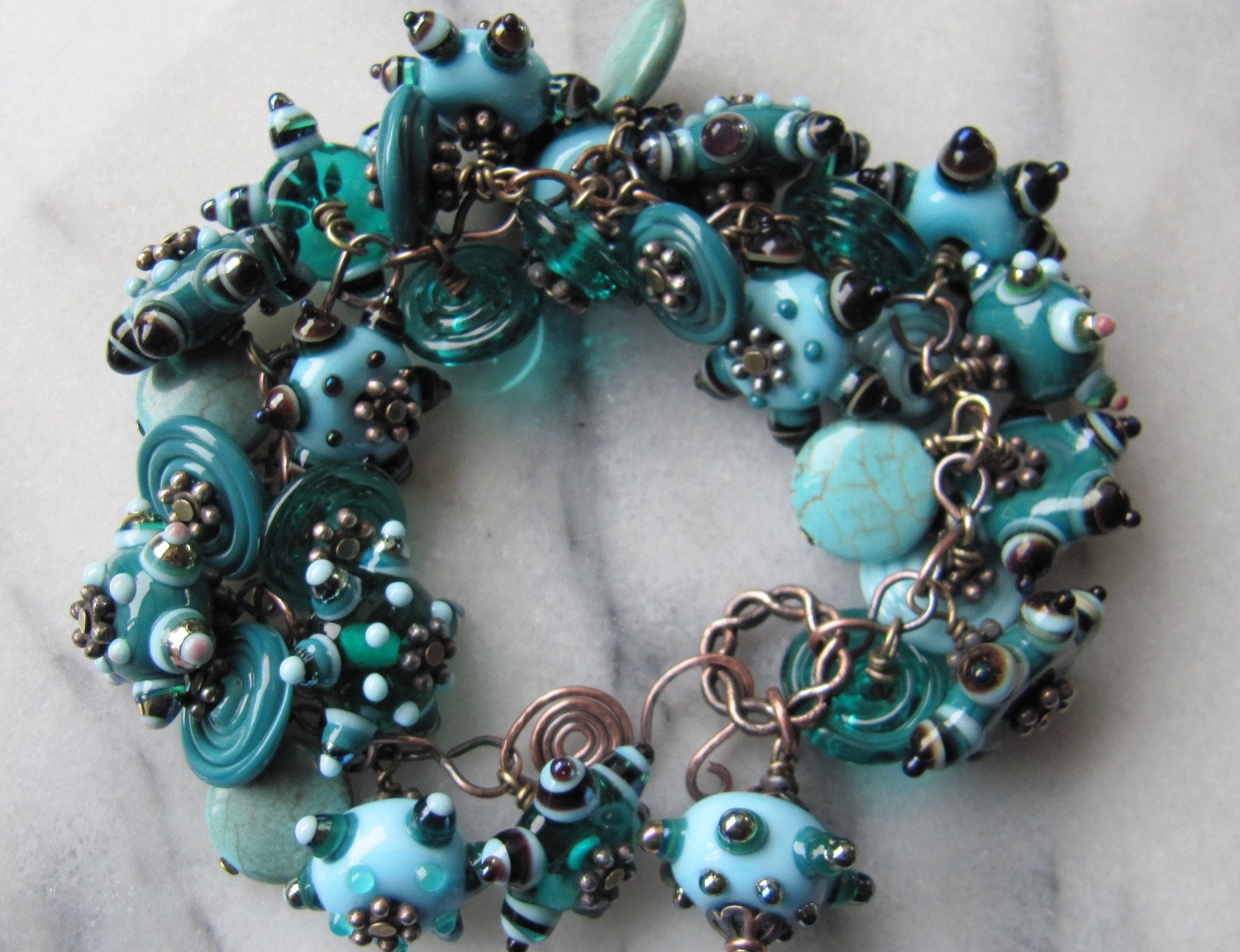 This bracelet contains loads of my handmade lampwork beads and discs, as well as a few pieces of turquoise for good measure.