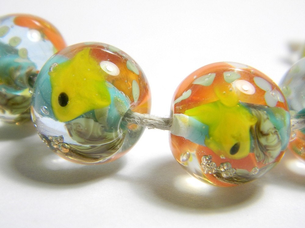 Each one is a little aquarium made with yellow, blue, orange, green and clear glass.