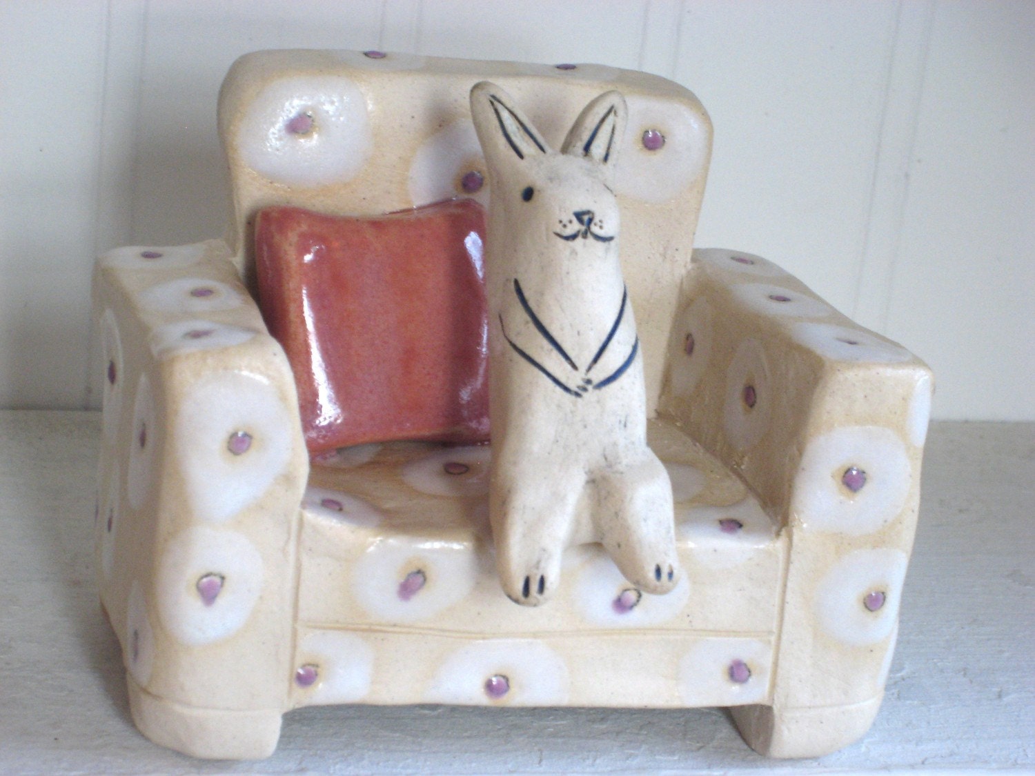 Cute Rabbit Sitting on Spotted Chair Ceramic Sculpture