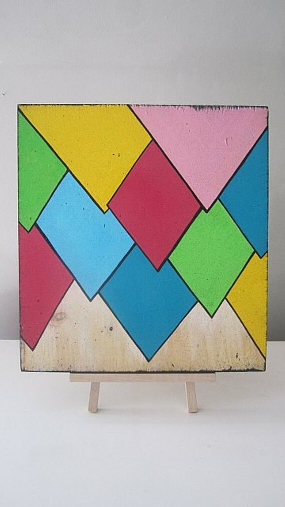 Multi-Colored cartoon points on a 12x14in repurposed piece of softwood
