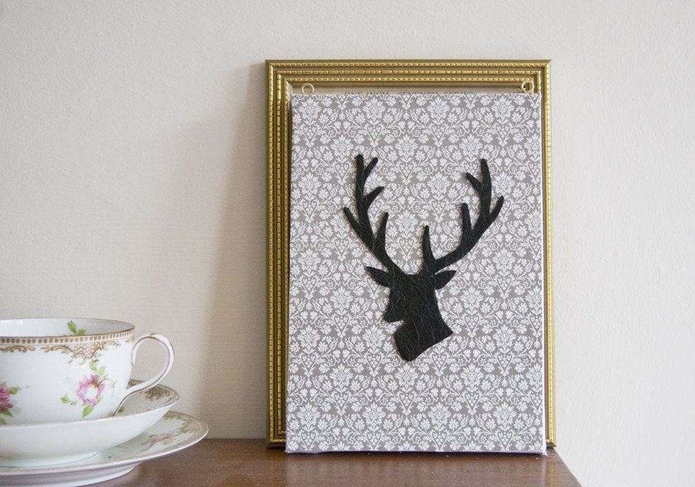 Leather stag silhouette on canvas