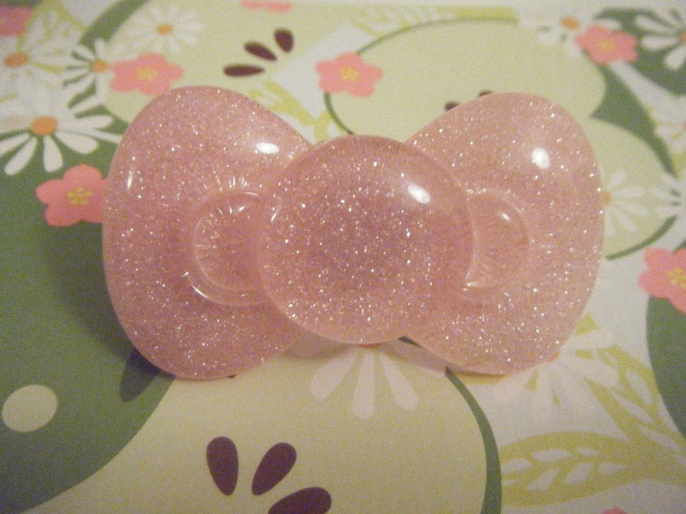 This is a cute, pink, large hello kitty bow ring.