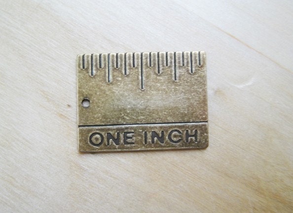 one-inch antique brass ruler charm, actual size. From snapcrafty