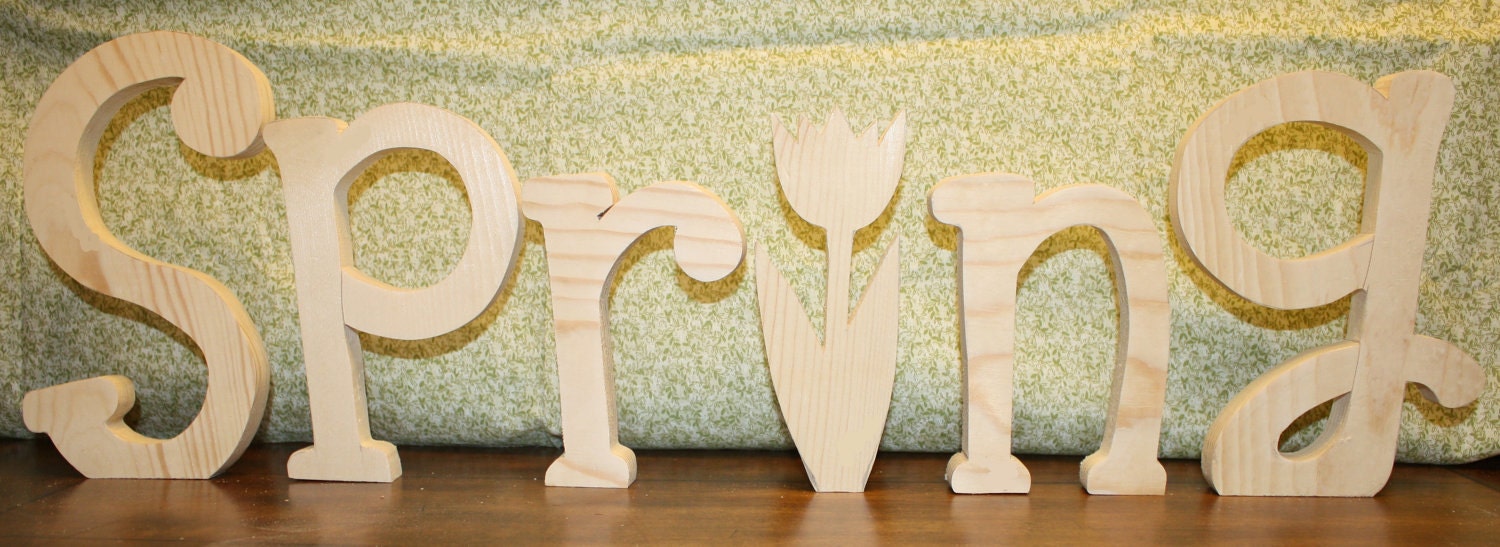 UNFINISHED SPRING wood letters with a tulip for the "I" and a butterfly as an extra bonus.