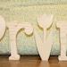 UNFINISHED SPRING wood letters with a tulip for the "I" and a butterfly as an extra bonus.